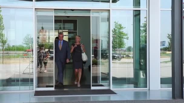 Diverse team of business people walk around their light and modern office building. — Stock Video