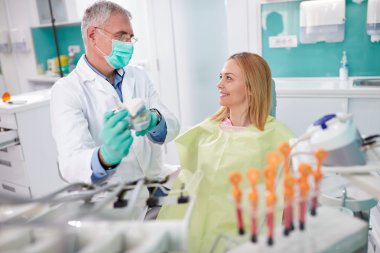 Dentist discuss about intervention with patient clipart