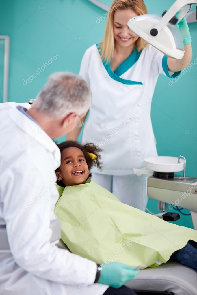 Smiling black child in dental chair