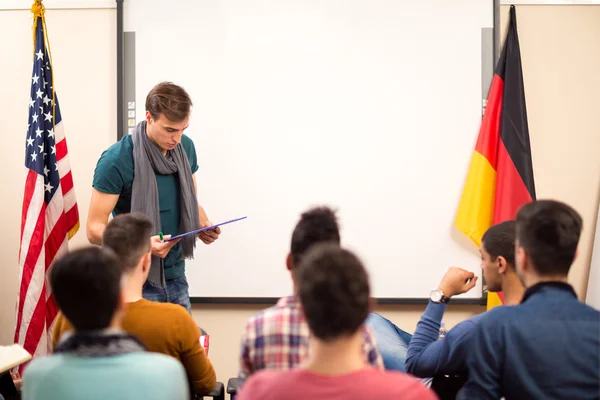 Assistant looks in his lecture material — Stock Photo, Image