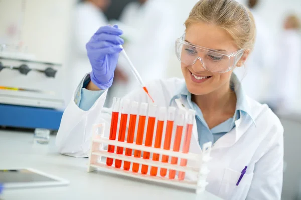 Female chemical assistant doing experiment in chemical laborator Royalty Free Stock Images