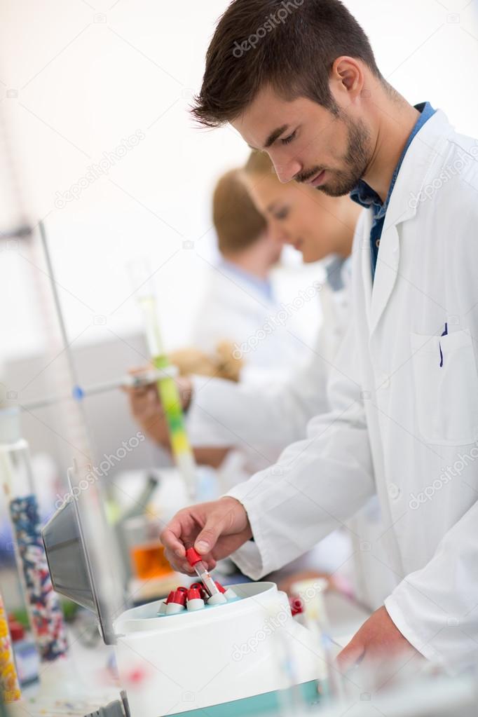 Chemical technician take test tube in shaker  
