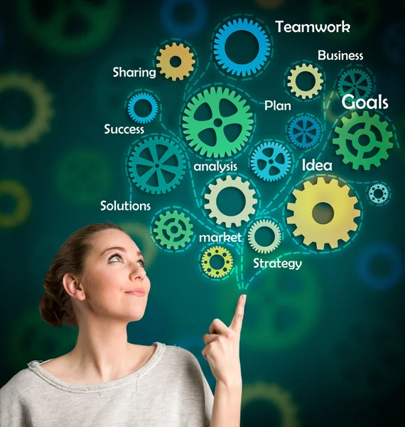 Woman with draw gears over head — Stock Photo, Image