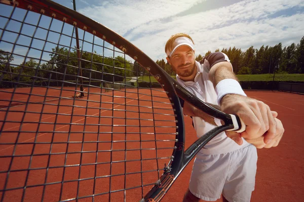 Racket in tennis player's hand — Stock Photo, Image