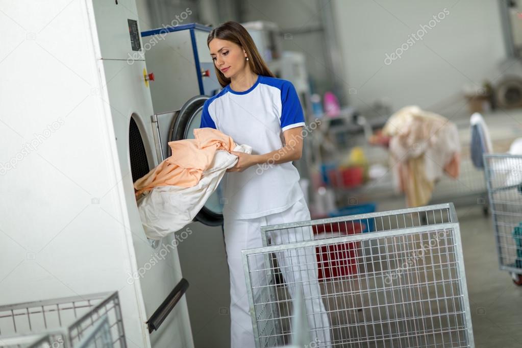 employees putting clothes in washing machine