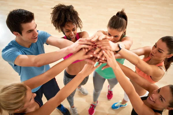 Exercisers group with hands over each other — Stock Photo, Image