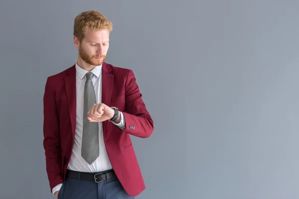 Young manager looking at his watc — Stock Photo, Image