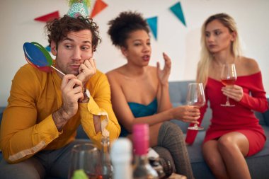 Partide iki etnik çeşitliliğe sahip kadınla birlikte sıkılmış beyaz bir adam. Corona, ikna edici kavram