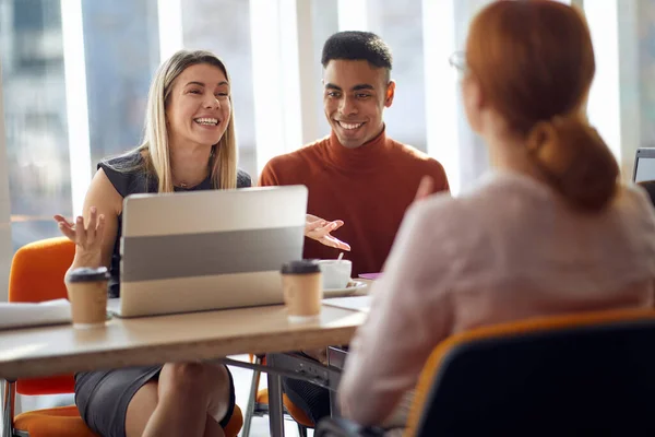 Company commission enjoying an interview in a pleasant atmosphere with a female applicant for a job. People, job, company, business concept.