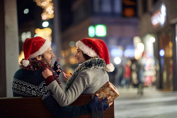 Egy Fiatal Szerelmespár Padon Városban Karácsonykor Egy Gyönyörű Ünnepi Estén — Stock Fotó