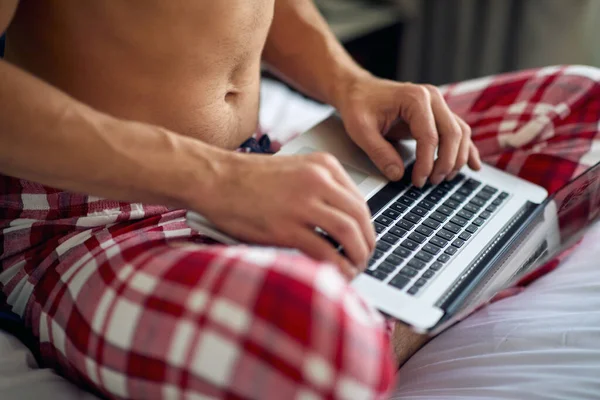 Young Handsome Man Sitting Bed Typing Laptop Hotel Room Beautiful — Stock Photo, Image