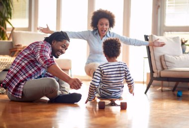 Mutlu bir ebeveyn evdeki neşeli bir atmosferde oğluyla yerde oynuyor. Aile, birlikte, aşk, oyun zamanı