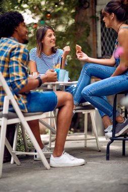 Güzel bir havada barın arka bahçesinde atıştıran neşeli arkadaşlar. Kaliteli arkadaşlık zamanı.