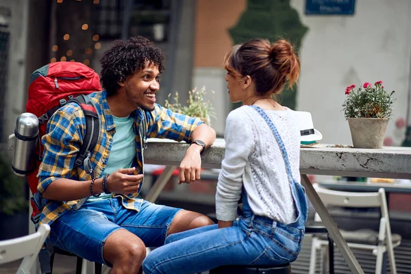 Friends having a pleasant talk at the bar\'s backyard on a beautiful weather. Quality friendship time together. Travel, tourism and people concept