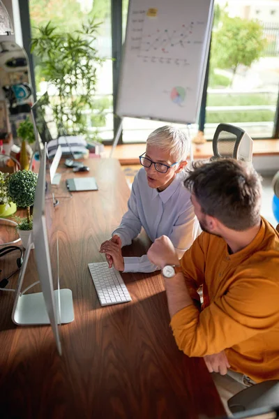 Young Happy Businessman Being Mentored Senior Female Partner Office Stock Picture