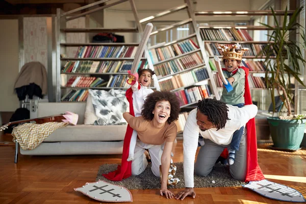 Cheerful afro american family playing together at home