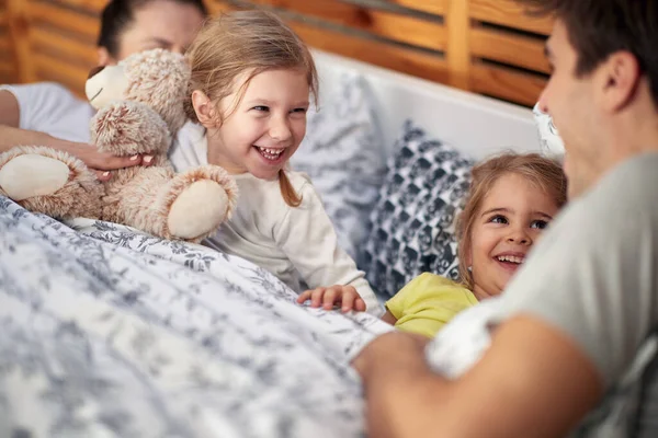 Young Happy Family Having Good Time While Laying Tucked Bed — Stock Photo, Image