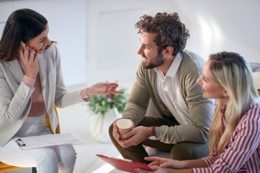 A group of young business people in a relaxed atmosphere at a meeting having a nice talk at a break. People, business, meeting