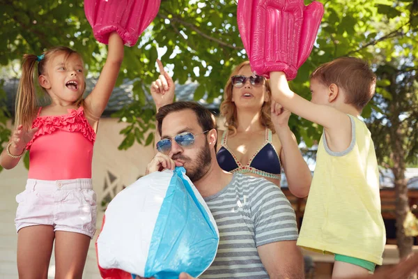 Cheerful Young Beautiful Family Four Playing Inflatable Toys — Stock Photo, Image