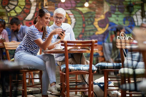 Caucasain Anciana Joven Amiga Viendo Algo Juntos Teléfono Celular Sonriendo — Foto de Stock