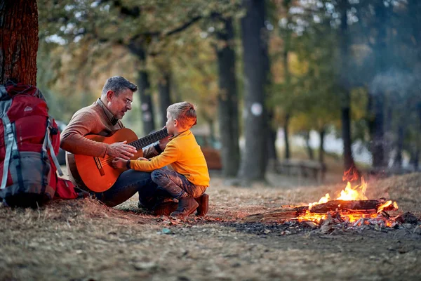Kakek Dan Cucu Menikmati Bermain Gitar Sekitar Api Unggun Hutan — Stok Foto