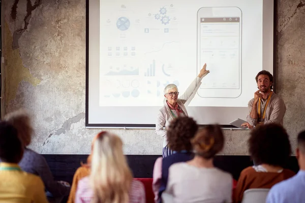 Elderly Caucasian Female Lecturing Students Together Her Male Assistant Showing — Stock Photo, Image