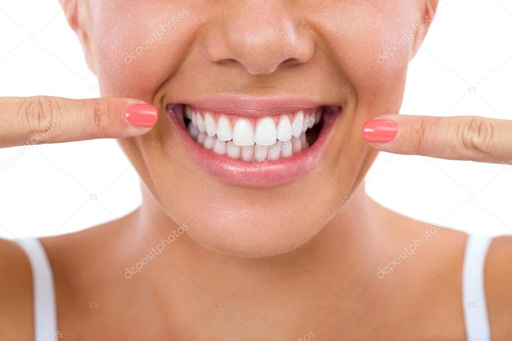 Woman showing her white teeth.