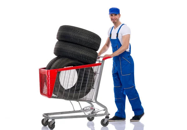 Young mechanic buy tires for the car — Stock Photo, Image