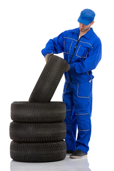 Motor mechanic with a tyre — Stock Photo, Image