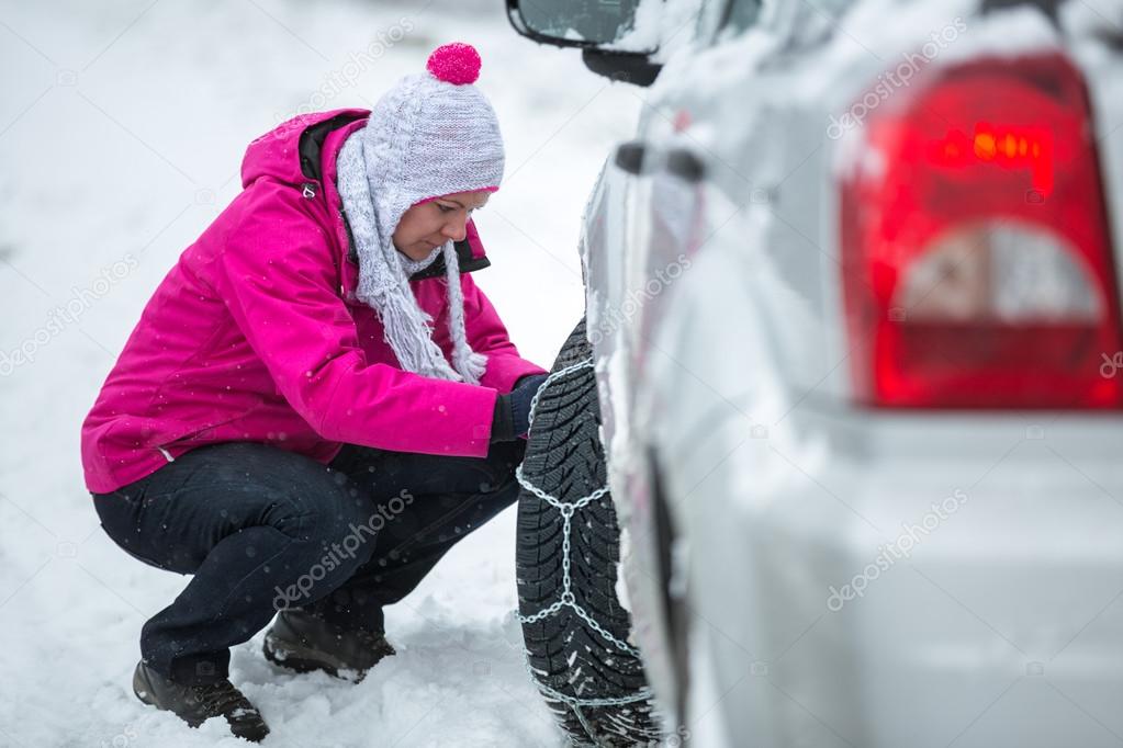 woman putting snow chains