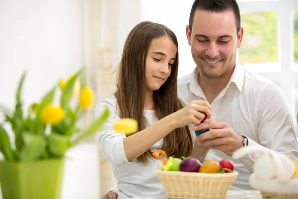 Daughter and father having fun with Easter eggs — Stock Photo, Image