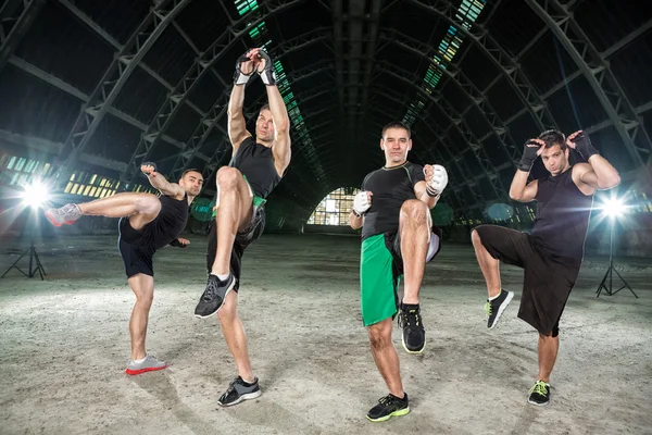 Four men practicing kick box — Stock Photo, Image