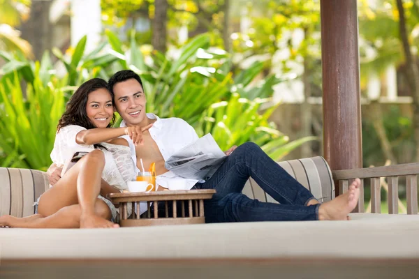 Young couple together comfort  sunbed — Stock Photo, Image