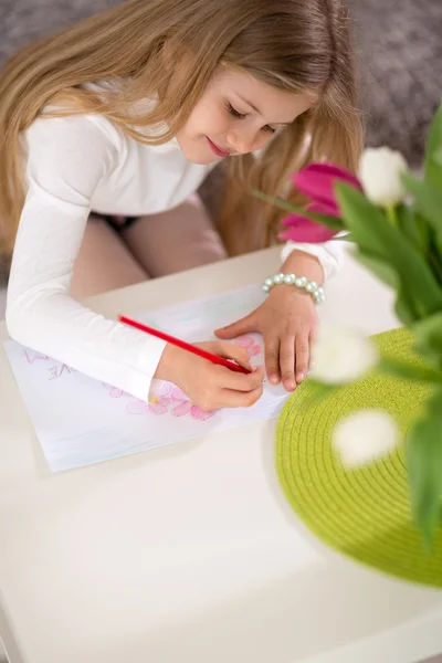 Adorable girl making gift card for mother day — Stock fotografie