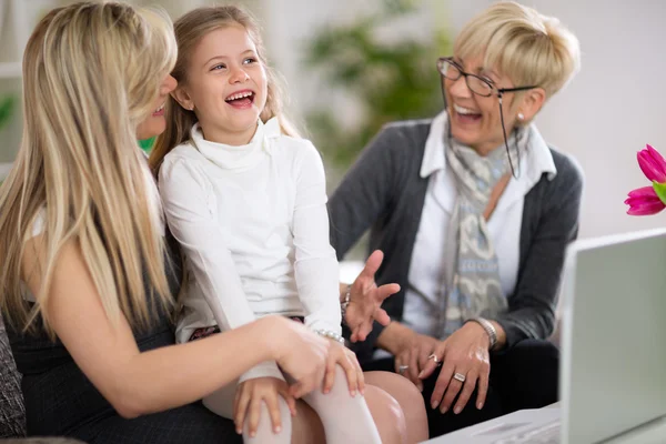Laughing little girl with mother and grandmother — Stockfoto