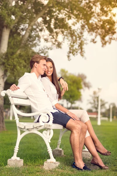 Paar genießt auf Bank im Park — Stockfoto