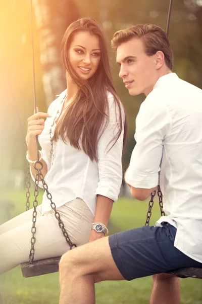 Love couple on swings — Stock Photo, Image