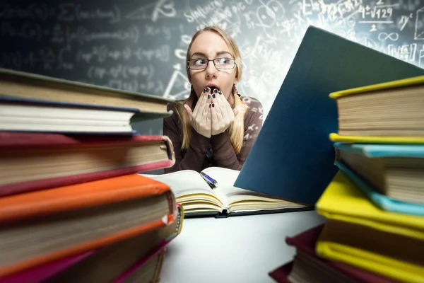 Shocked girl looking in open book — Stock Photo, Image
