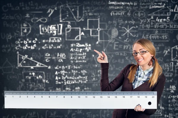 Smiling student with a big ruler — Stock Photo, Image