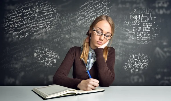 Thinking  student sitting at a desk Stock Image