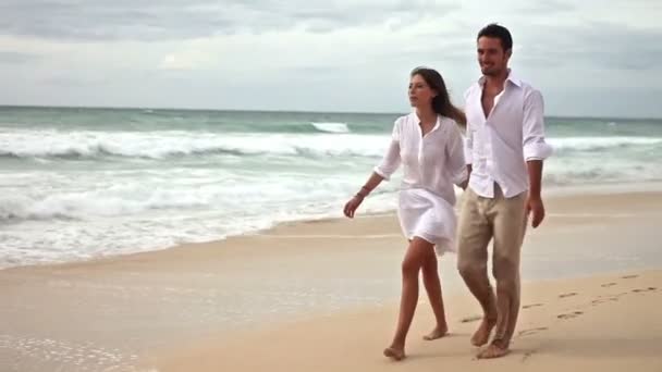 Щаслива пара закоханих розважається на пляжі, повільний рух — стокове відео