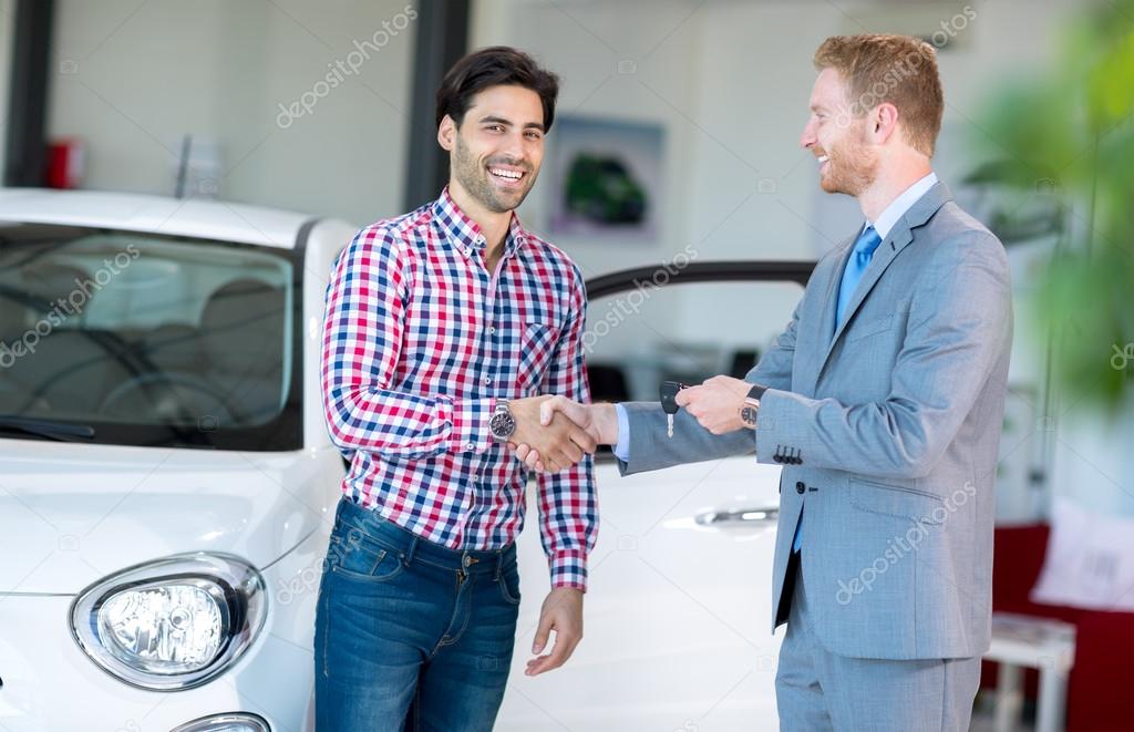 salesman and client at the car saloon