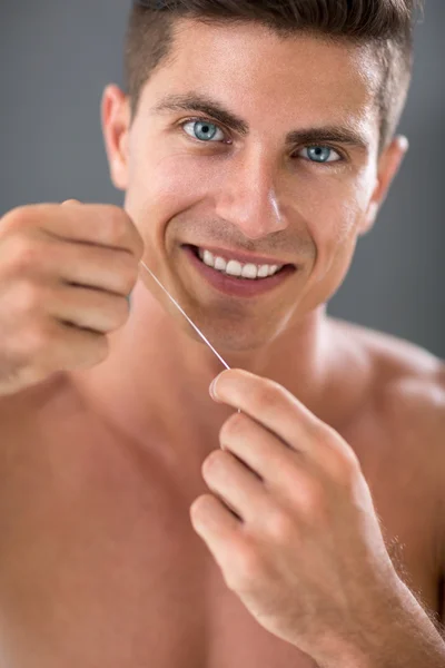 Cleaning teeth with dental floss — Stock Photo, Image