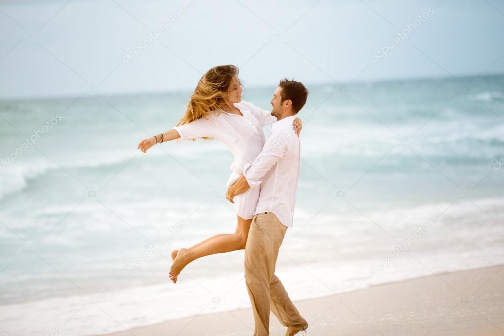 couple enjoying each other on a beach.