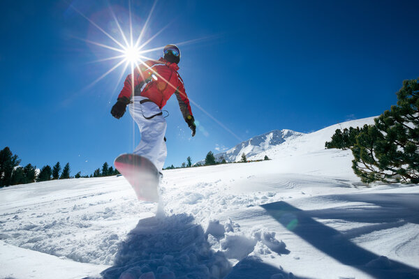 Snowboarder jumping through air