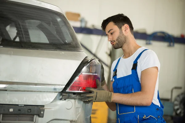 Mechanic fixes backlight — Stock Photo, Image