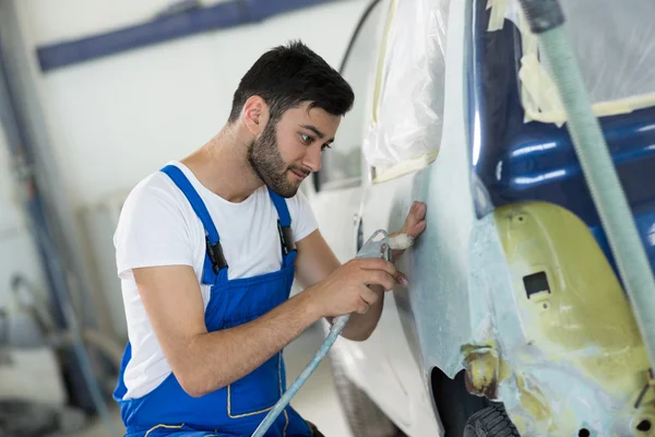 Trabajador preparar parte del cuerpo para la pintura —  Fotos de Stock