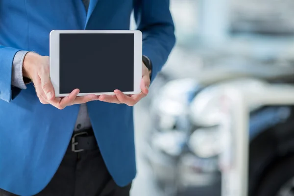 Car dealer holding pc tablet — Stock Photo, Image