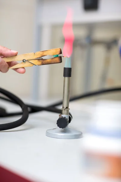 Close up of laboratory burner and tongs — Stock Photo, Image