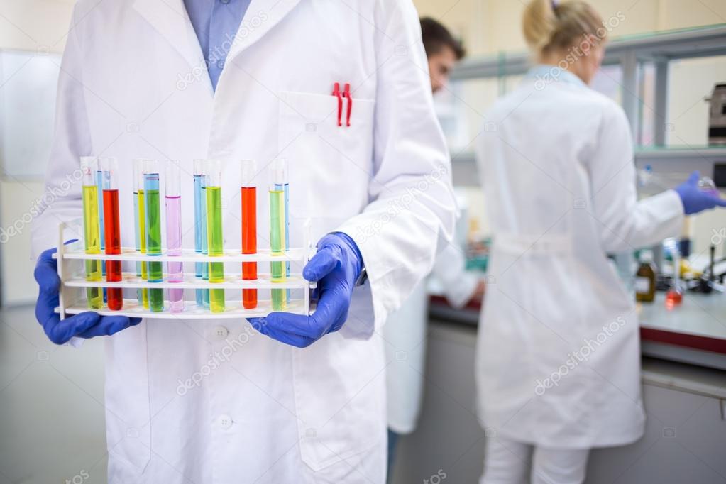 Close up of hands holding tests tubes